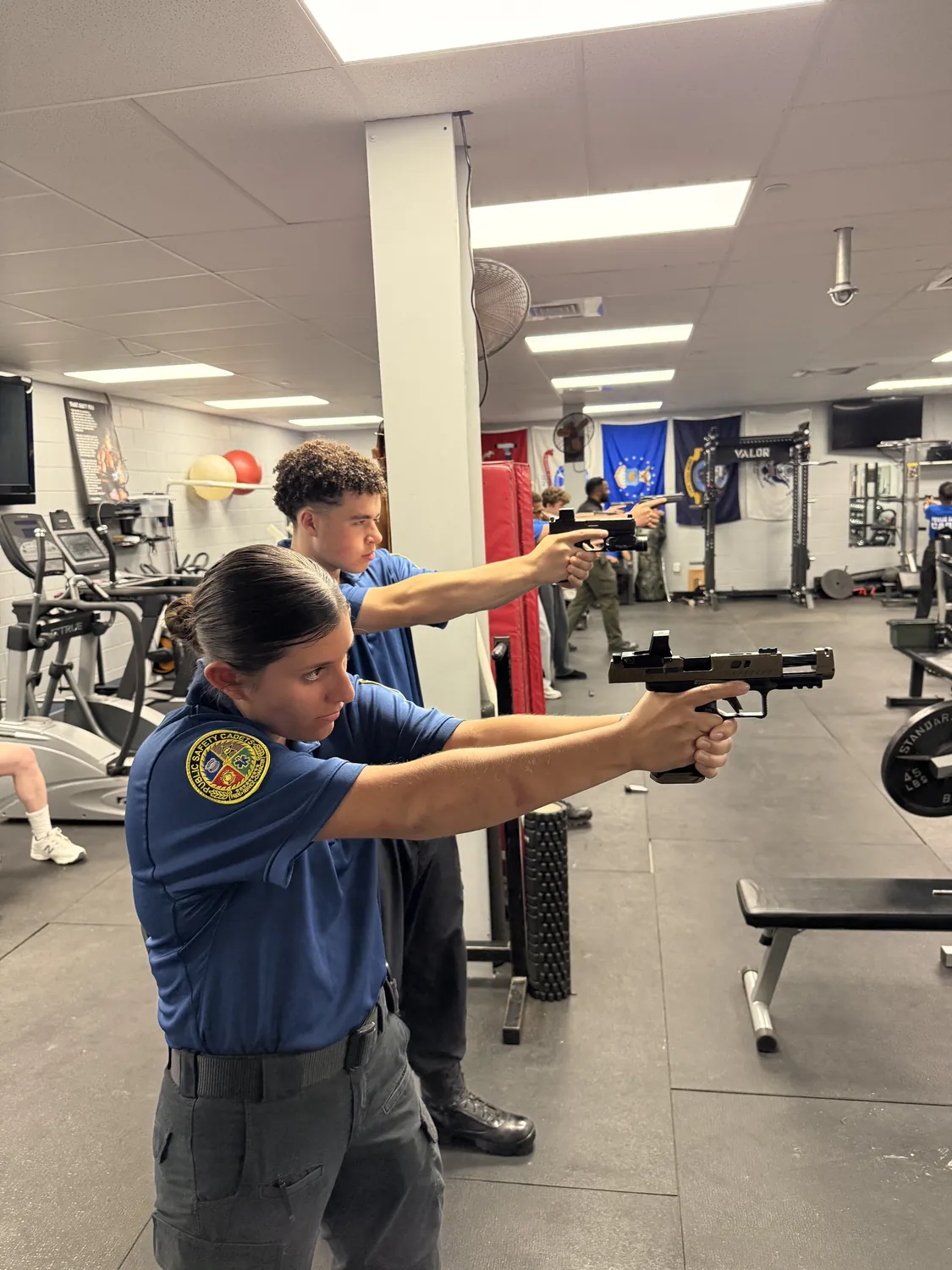 Cadets practicing firearm safety and handling with instructors