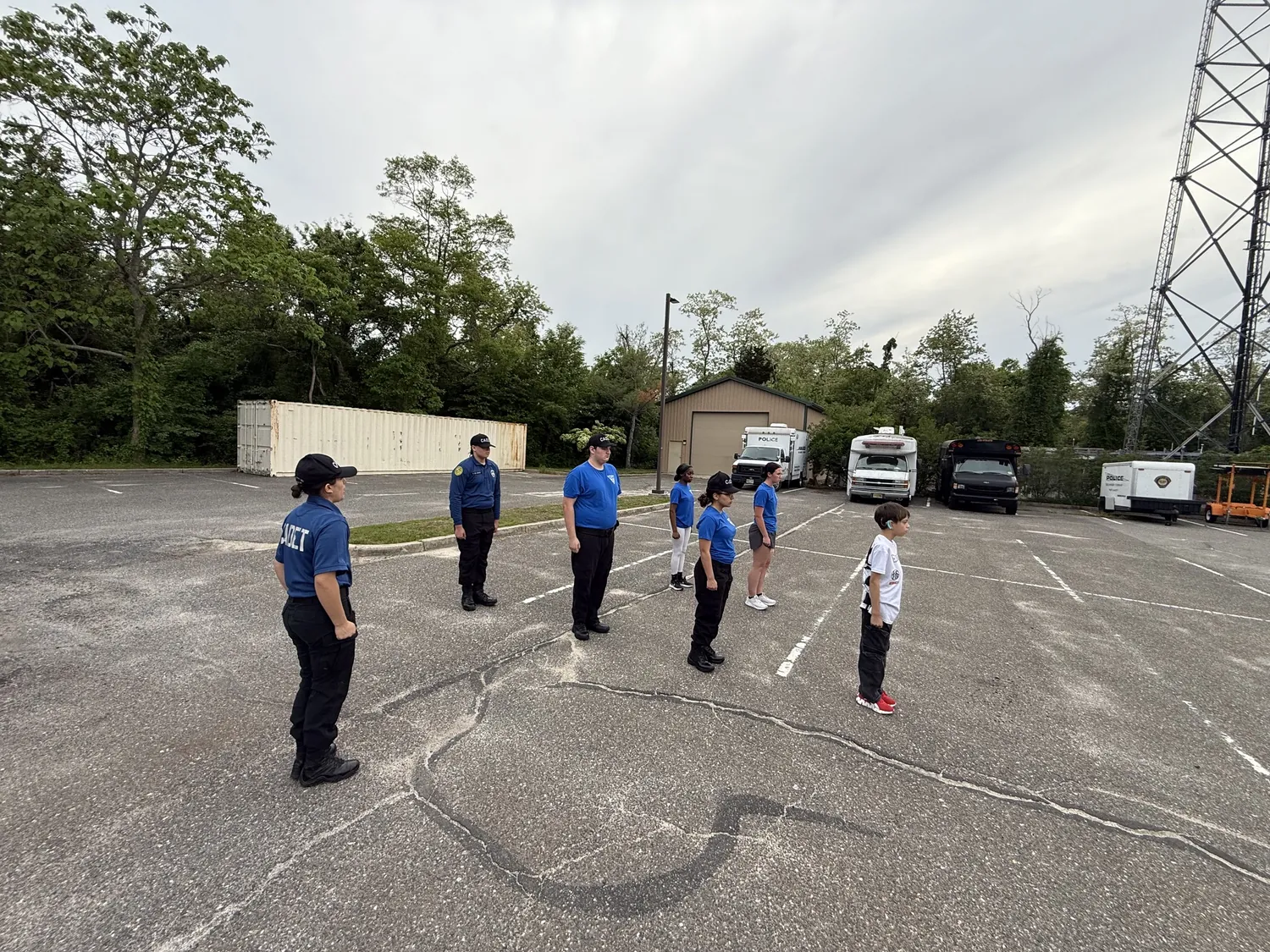 Cadets standing in formation during outdoor drill in a parking lot