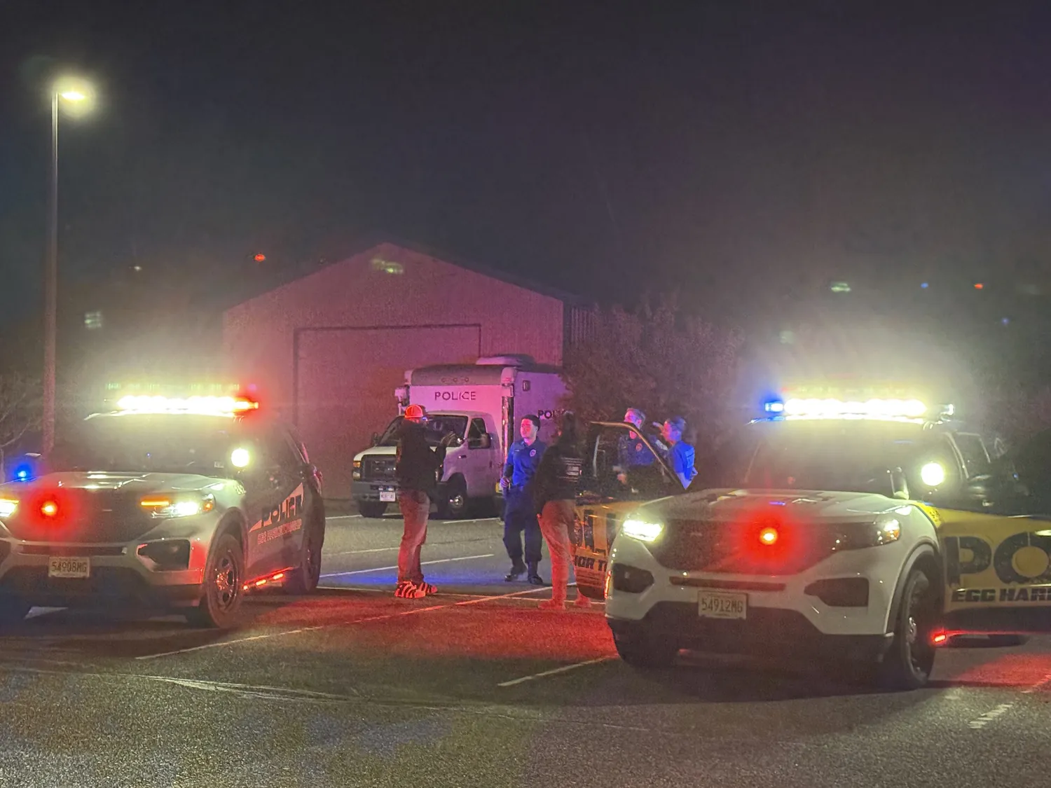 Egg Harbor Township police vehicles with emergency lights during a nighttime operation