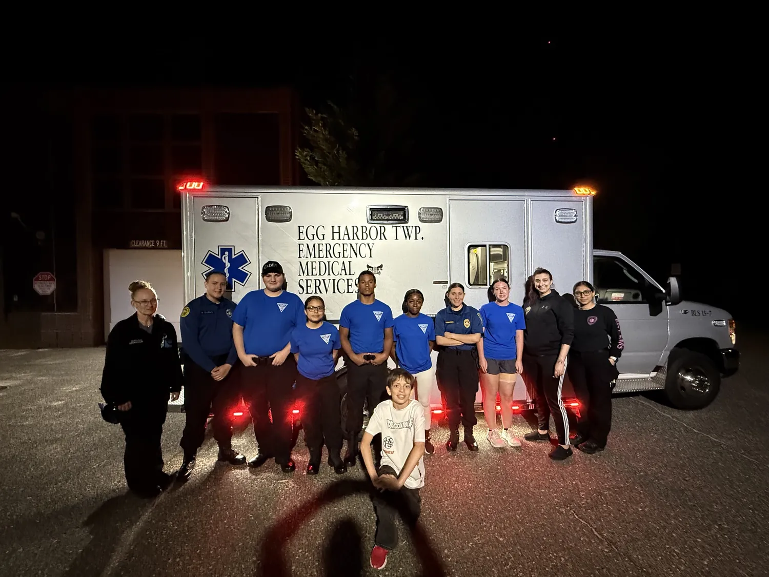 Post 94 cadets pose for a group photo in front of an Egg Harbor Township EMS ambulance